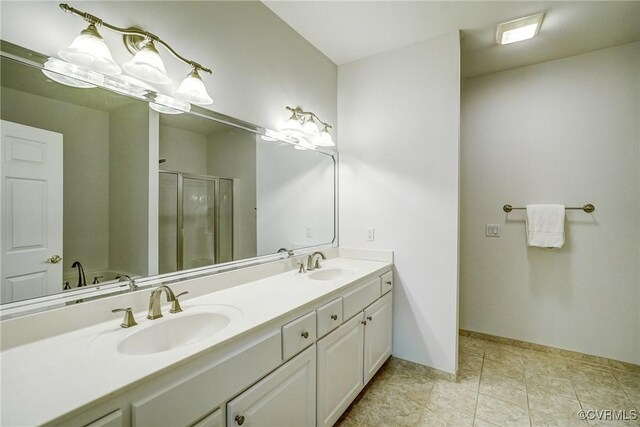 full bathroom featuring baseboards, double vanity, a sink, and a shower stall