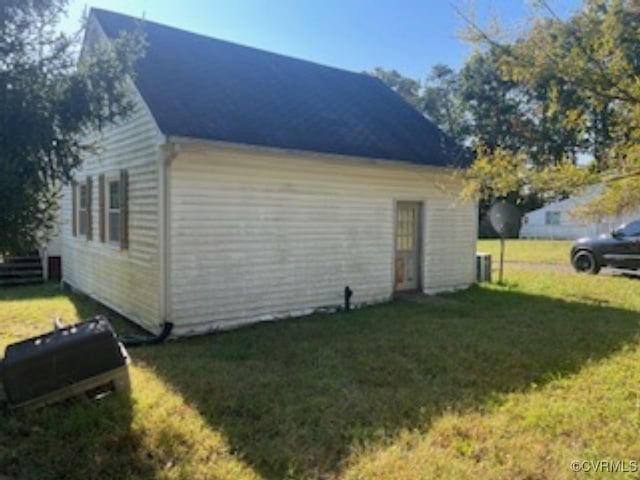 view of outbuilding featuring a yard