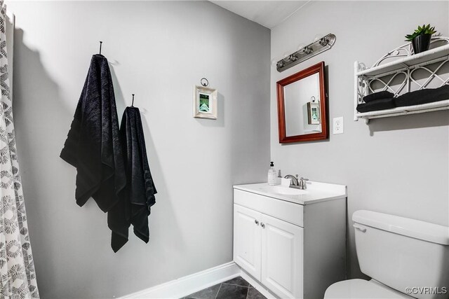 bathroom with vanity, toilet, and tile patterned flooring