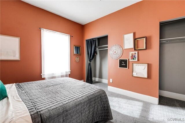 bedroom featuring two closets and carpet