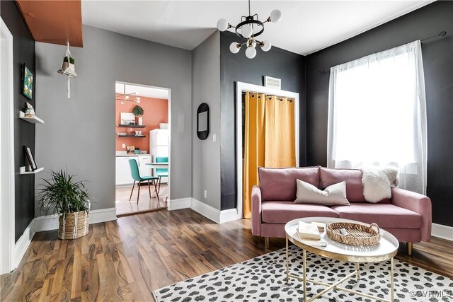 living room featuring dark hardwood / wood-style floors and a chandelier