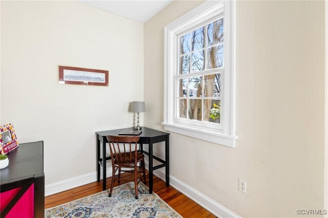 office space featuring baseboards and wood finished floors