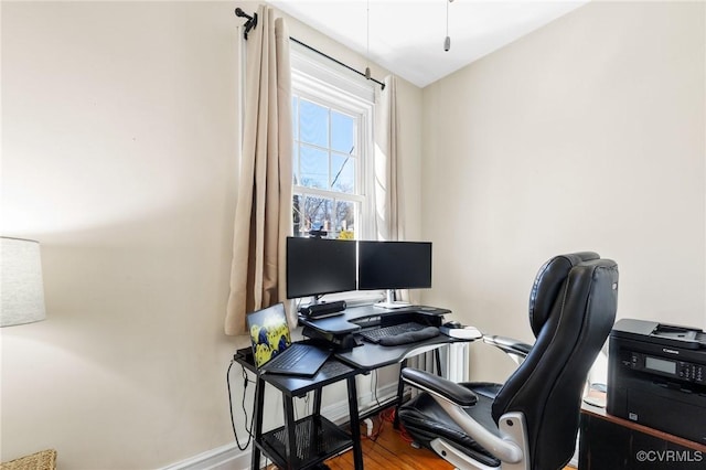 office space with baseboards and wood finished floors