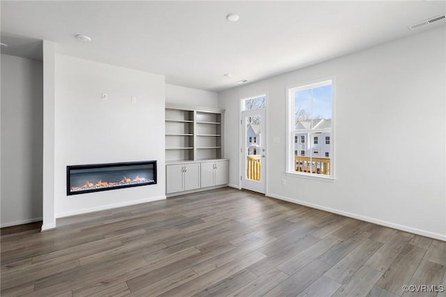 unfurnished living room featuring wood-type flooring