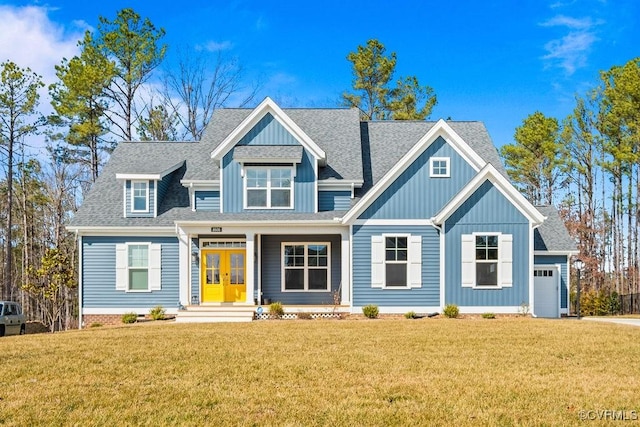 view of front of home featuring a garage, a shingled roof, a front lawn, and french doors