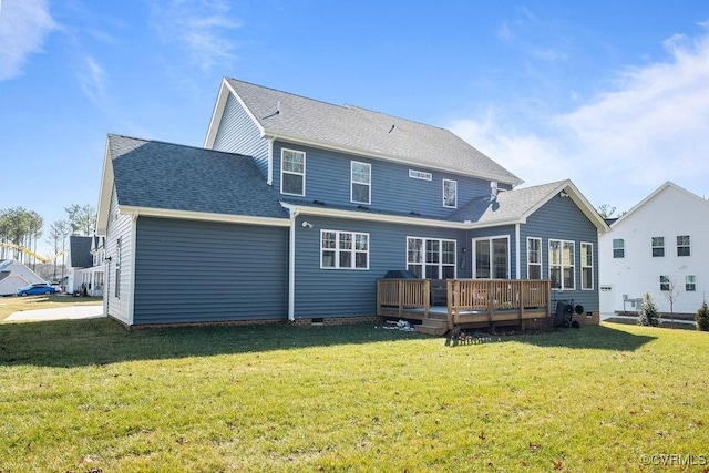 back of house with crawl space, roof with shingles, a yard, and a wooden deck