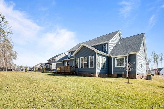 exterior space with roof with shingles, a lawn, central AC unit, crawl space, and a deck