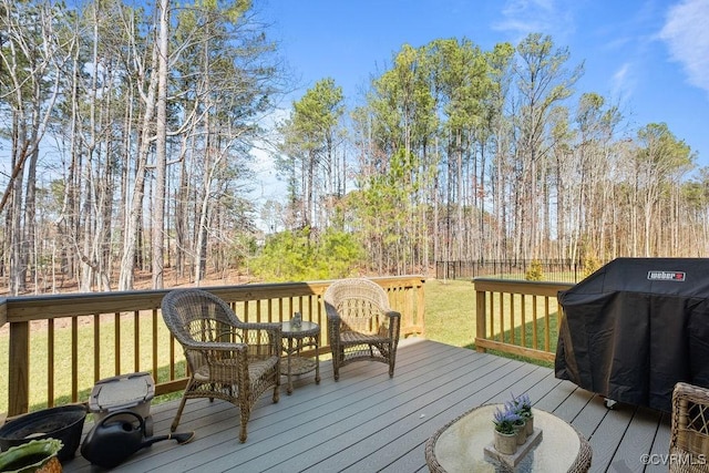 deck with a yard, fence, and area for grilling