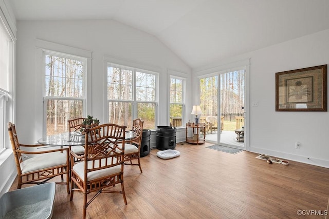 sunroom featuring lofted ceiling and plenty of natural light