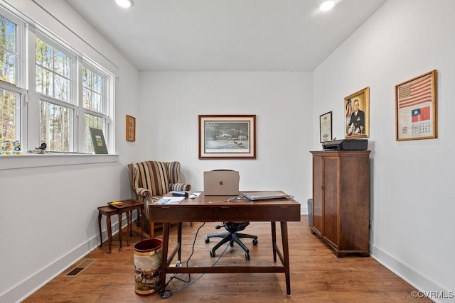 office space featuring recessed lighting, wood finished floors, visible vents, and baseboards