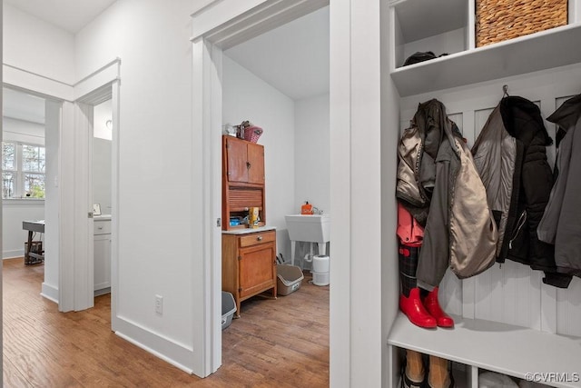 mudroom featuring light wood-style floors and baseboards