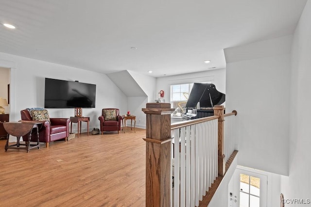 interior space with light wood-style floors, recessed lighting, baseboards, and an upstairs landing