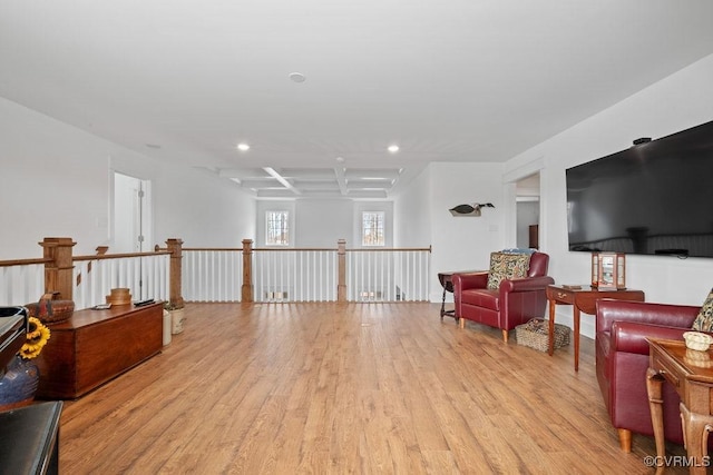 living area with light wood finished floors, coffered ceiling, an upstairs landing, and recessed lighting