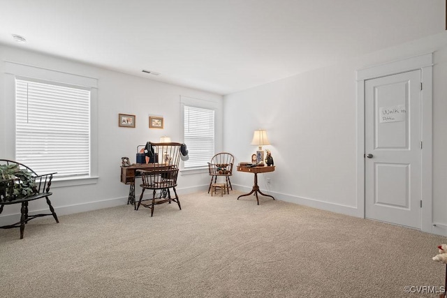 sitting room with carpet floors, visible vents, and baseboards