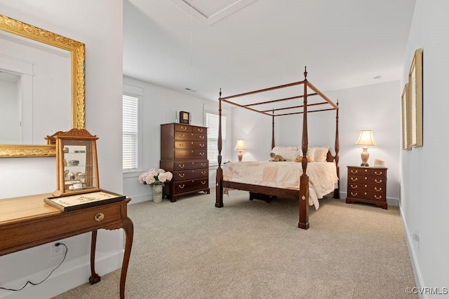 carpeted bedroom with attic access and baseboards