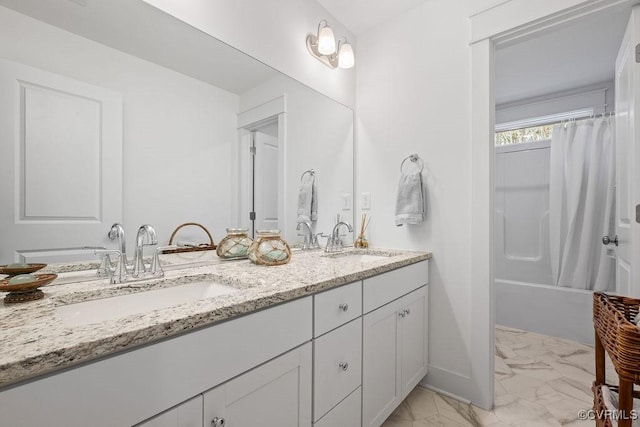 bathroom featuring marble finish floor, double vanity, a sink, and shower / tub combo with curtain