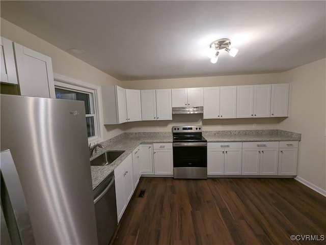 kitchen with light stone counters, sink, stainless steel appliances, and white cabinets