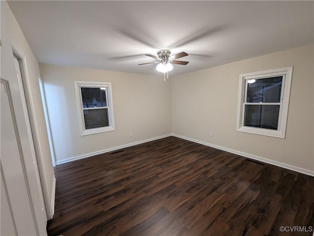 unfurnished room with dark hardwood / wood-style floors and ceiling fan