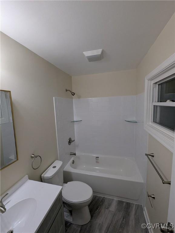 full bathroom featuring vanity, wood-type flooring, toilet, and shower / bath combination