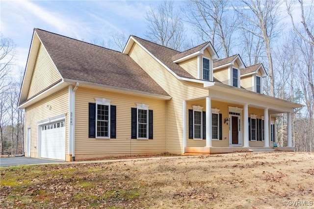 cape cod-style house with a garage and covered porch