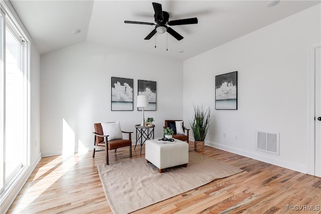 sitting room with vaulted ceiling, ceiling fan, and light hardwood / wood-style floors