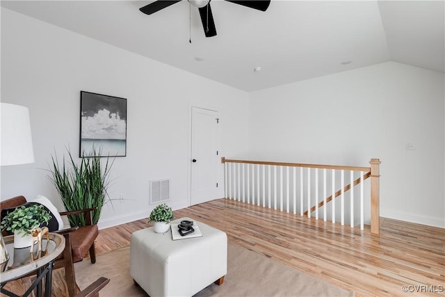 sitting room featuring vaulted ceiling and light wood-type flooring