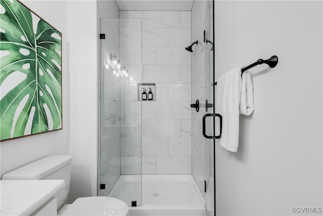 bathroom with vanity, toilet, and a shower with shower door