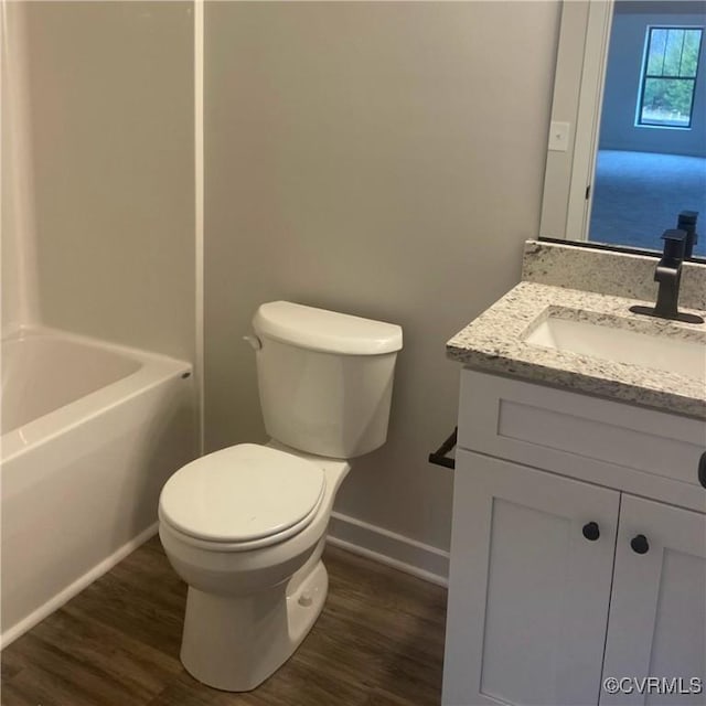 bathroom with vanity, hardwood / wood-style floors, and toilet