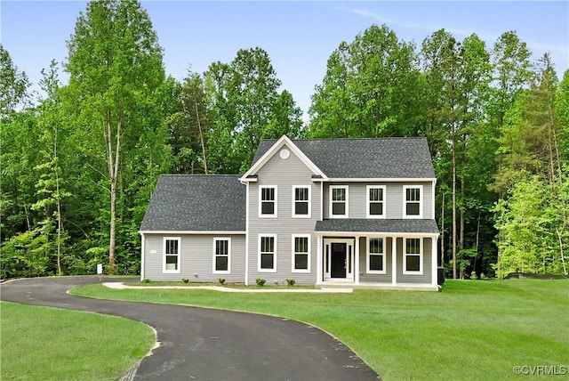 colonial-style house featuring a front yard