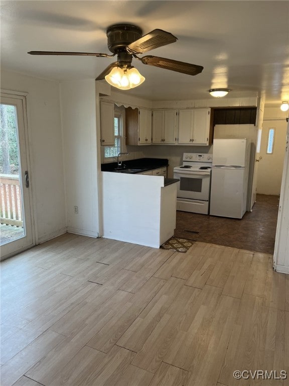 kitchen featuring ceiling fan, light wood-type flooring, sink, and white appliances