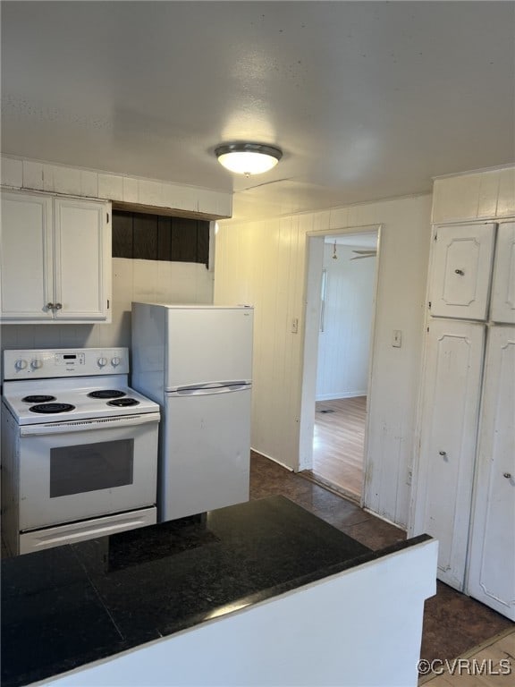 kitchen with white cabinetry and white appliances