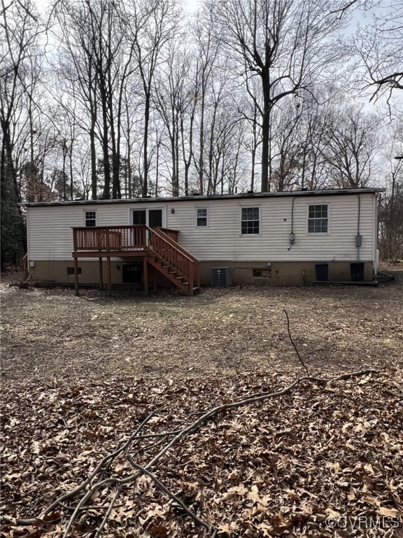 back of property with central air condition unit and a deck