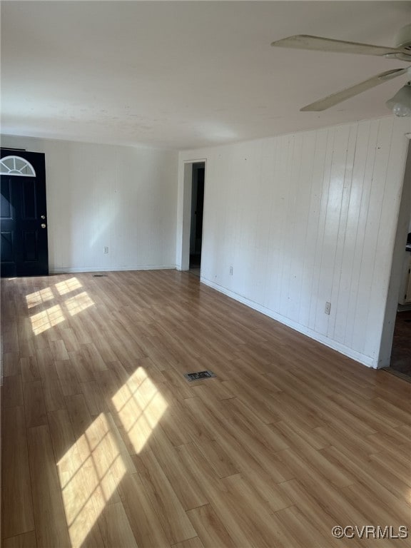 unfurnished room with hardwood / wood-style flooring