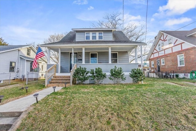 bungalow-style house with covered porch and a front lawn