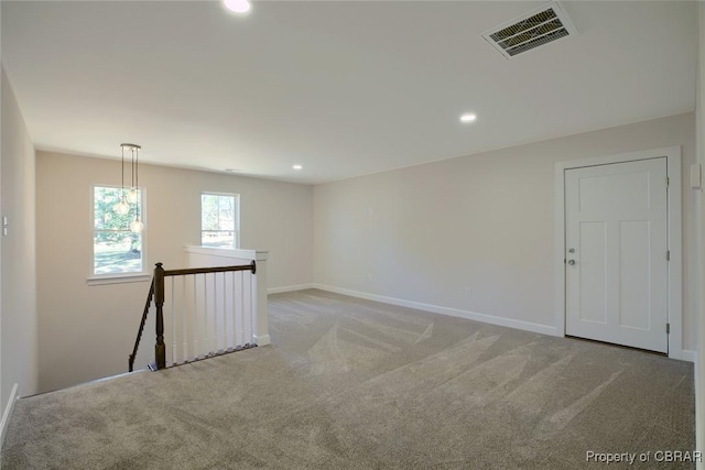 unfurnished room with light carpet