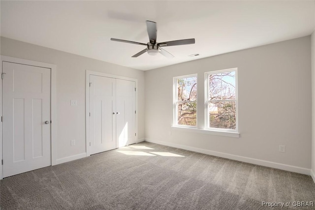 unfurnished bedroom featuring carpet flooring, ceiling fan, and a closet