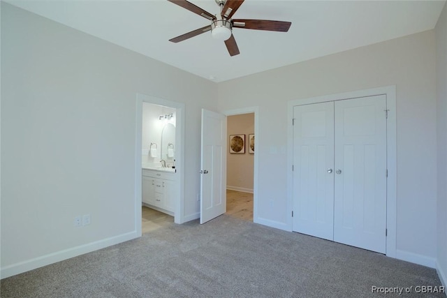 unfurnished bedroom featuring ceiling fan, light colored carpet, connected bathroom, and a closet