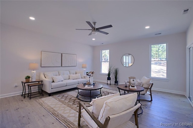 living room featuring ceiling fan and light wood-type flooring