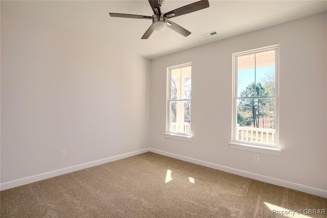 carpeted empty room featuring ceiling fan