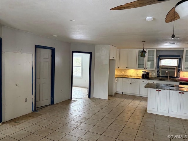 kitchen with backsplash, plenty of natural light, decorative light fixtures, and white cabinets