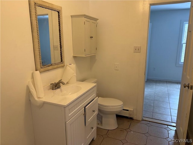 bathroom featuring a baseboard radiator, vanity, tile patterned floors, and toilet