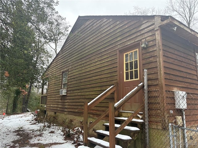 view of snowy exterior with cooling unit