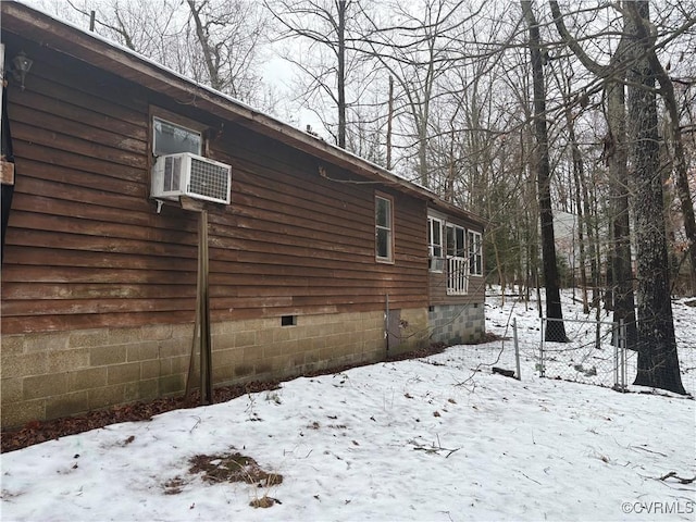 view of snowy exterior featuring cooling unit