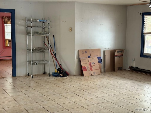 tiled empty room with a baseboard radiator