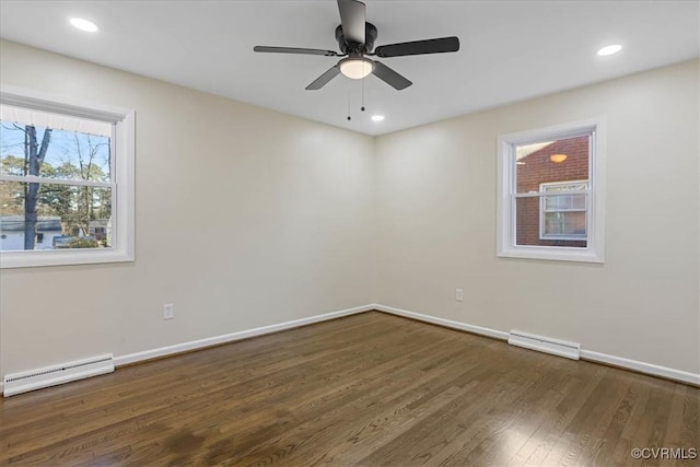 empty room with a baseboard radiator, dark hardwood / wood-style floors, and ceiling fan