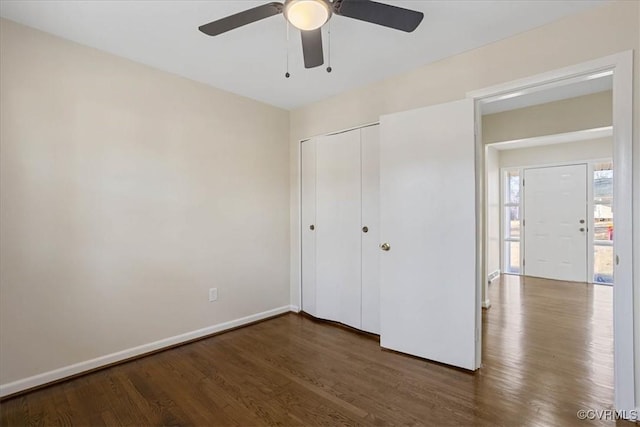 unfurnished bedroom with ceiling fan, dark hardwood / wood-style floors, and a closet