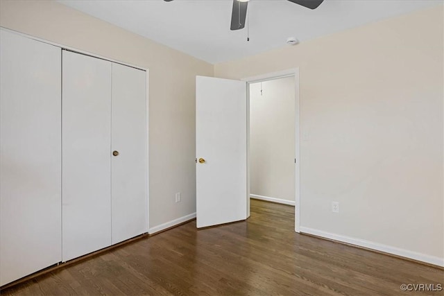 unfurnished bedroom featuring dark hardwood / wood-style floors, ceiling fan, and a closet