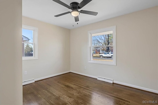 spare room with a baseboard radiator, dark hardwood / wood-style floors, and ceiling fan