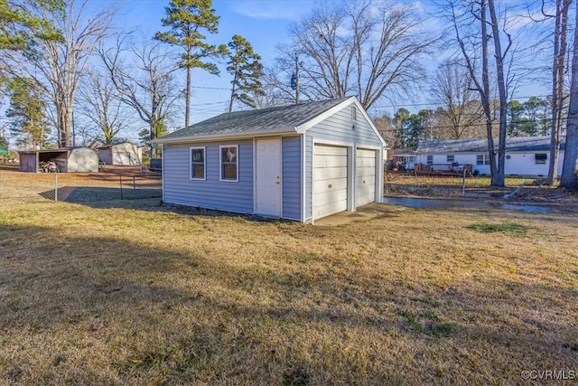 view of outbuilding with a garage and a lawn