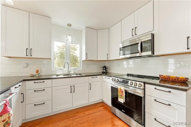 kitchen featuring white cabinetry, appliances with stainless steel finishes, and sink